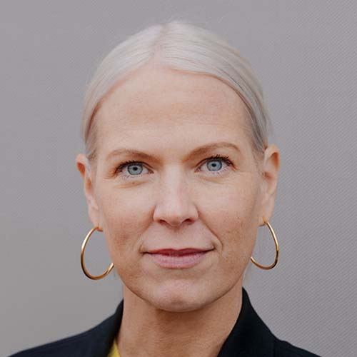 a woman with blonde hair and big hoop earrings